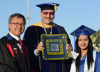 Photo of Chancellor Blumenthal with SMC President Chui Tsang and graduate Lorena Carpinteyro.