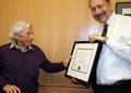 Presenting philanthropist Jack Baskin with a framed certificate to honor 32 years of service as a trustee of the UCSC Foundation, July 2010.